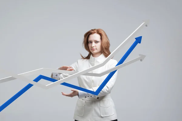 Businesswoman working with growth graph on grey background — Stock Photo, Image