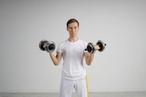 Young Man doing Exercise with Dumbbells. — Stock Photo, Image