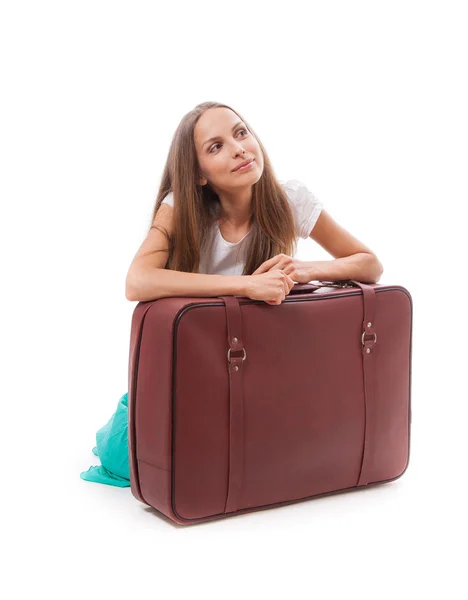 Girl sitting near a suitcase — Stock Photo, Image