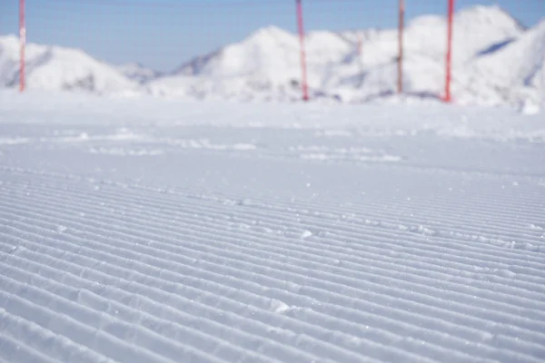 Fresh snow groomer tracks on a ski piste — Stock Photo, Image