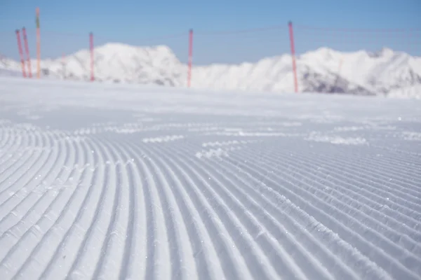 Verse sneeuw groomer tracks op een skipiste — Stockfoto