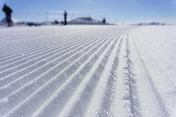 Fresh snow groomer tracks on a ski piste — Stock Photo, Image