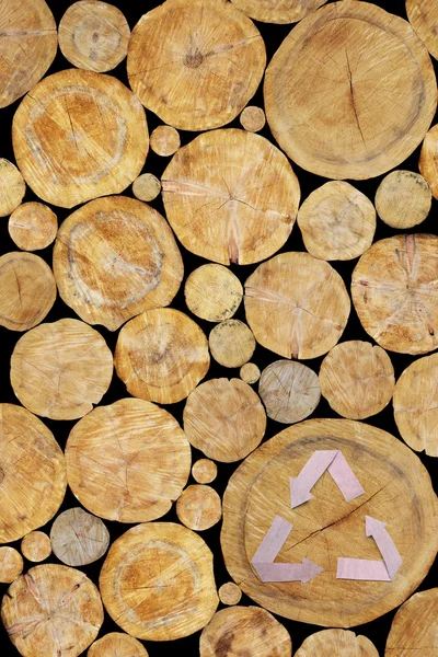 Stacked Logs Background with recycle symbol — Stock Photo, Image