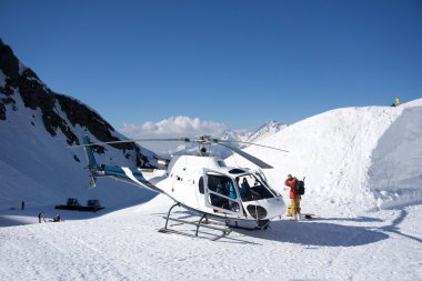 White rescue helicopter parked in the mountains clipart