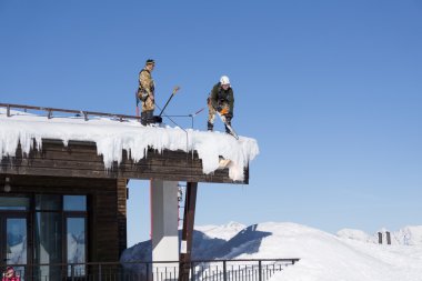 Sochi, Rusya Federasyonu - 22 Ocak 2015: kar ve buz sarkıtları çatıdan endüstriyel dağcılar çıkar