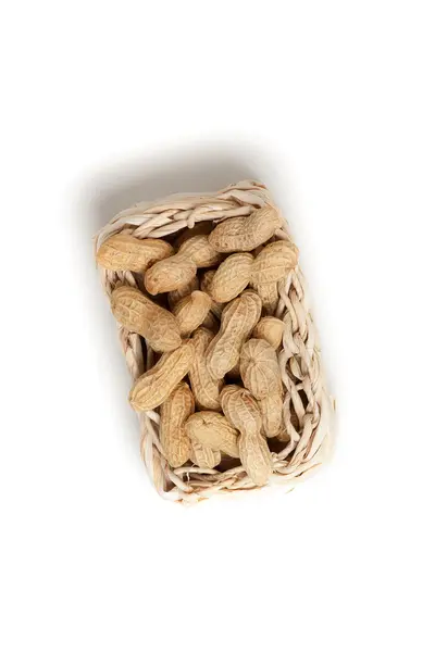 Peanuts isolated in basket on white background — Stock Photo, Image