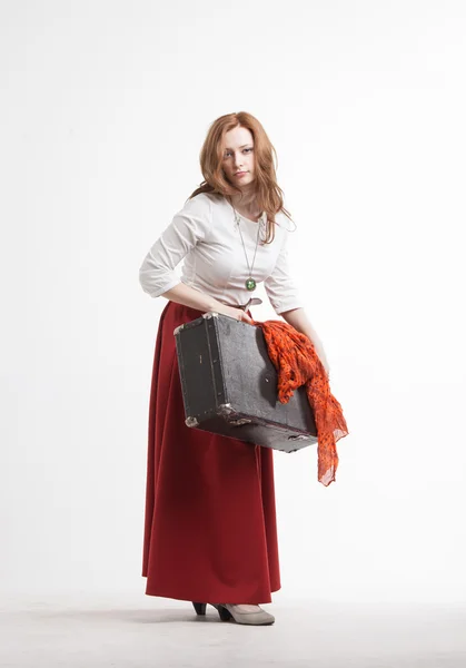 Woman in vintage red skirt with a suitcase — Stock Photo, Image