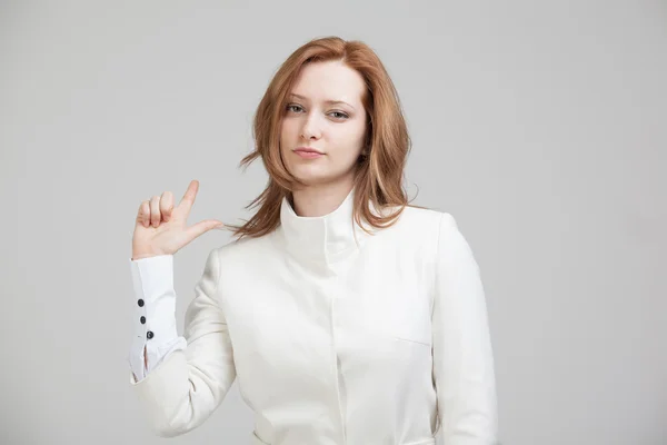 Mujer con chaqueta blanca señalando un dedo — Foto de Stock