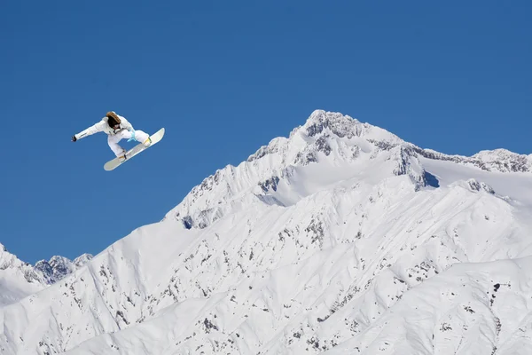 Flying snowboarder on mountains — Stock Photo, Image
