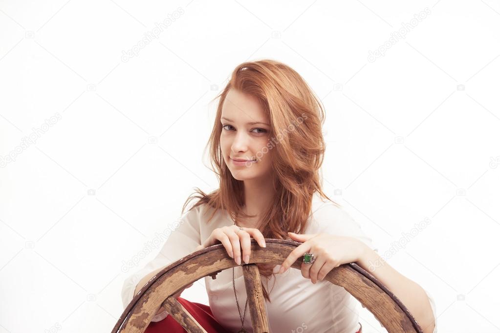 young woman with an old wagon wheel