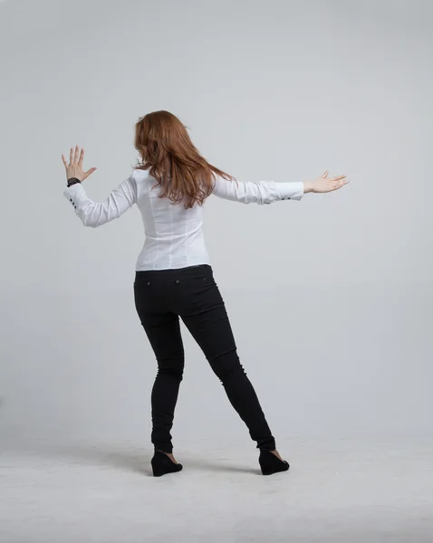 Young girl stands back and working with virtual screen — Stock Photo, Image