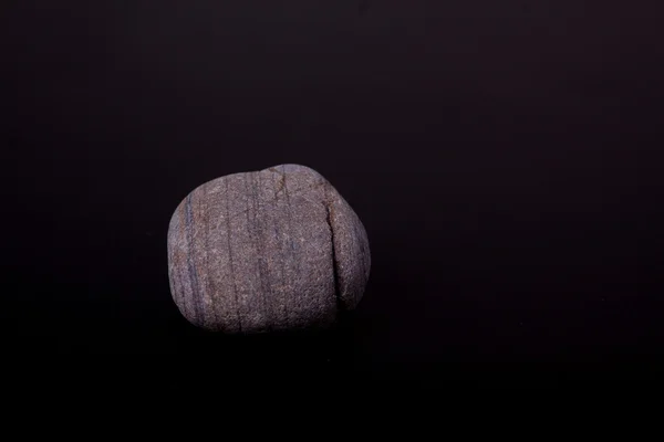 Pebble on black — Stock Photo, Image