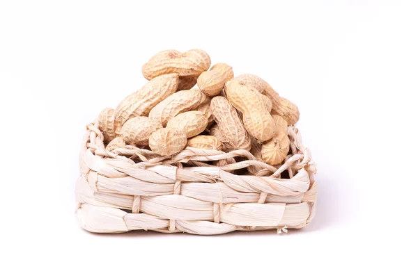 Peanuts isolated in basket on white background Stock Photo