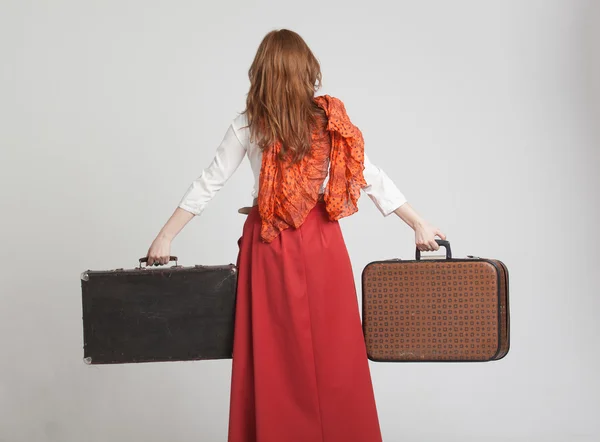 Woman in vintage red skirt with suitcases — Stock Photo, Image