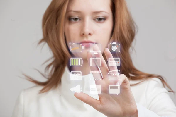 Woman pressing high tech type of modern multimedia buttons on a virtual background — Stock Photo, Image