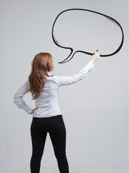 woman writes in a painted  speech cloud