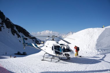 White rescue helicopter parked in the mountains clipart