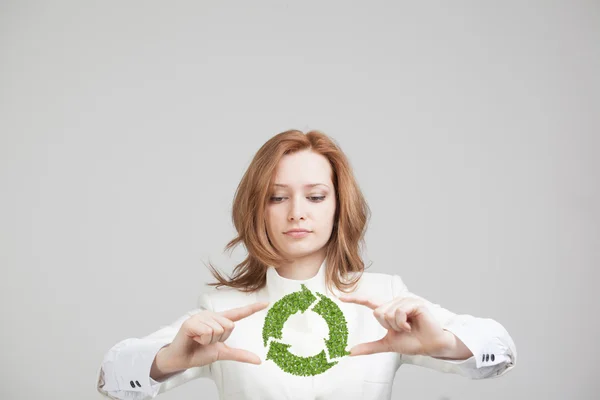 Mujer sosteniendo el símbolo de reciclaje en sus manos — Foto de Stock