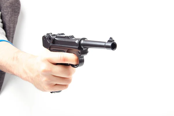 Чоловік тримає пістолет, ізольований на білому . — стокове фото