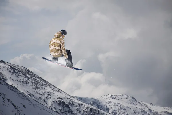 Dağlar üzerinde uçan snowboarder — Stok fotoğraf