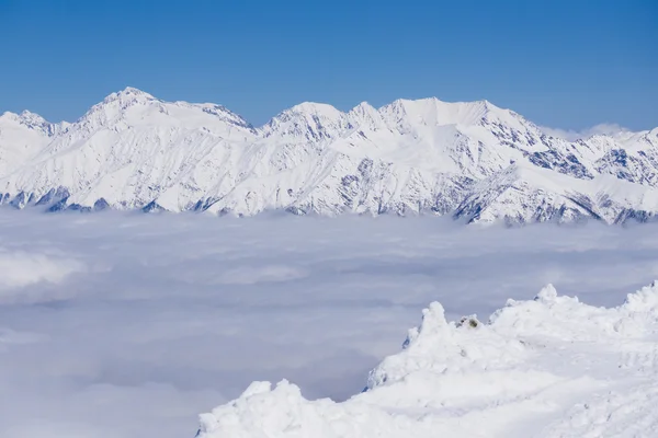 Visa på bergen och blå himmel ovanför molnen, Krasnaya Polyana, Sochi, Ryssland — Stockfoto