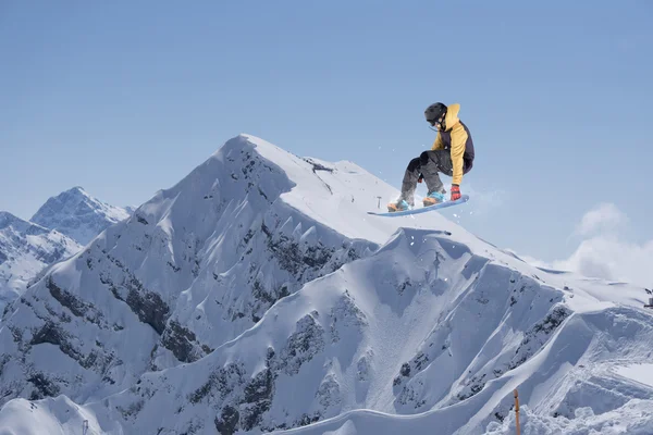 Flygande snowboardåkare på berg — Stockfoto