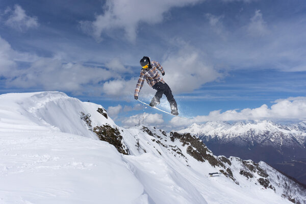 Flying snowboarder on mountains, extreme sport