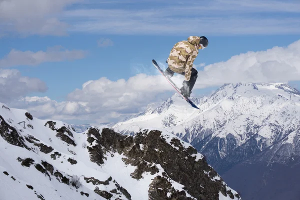 Dağlar üzerinde uçan snowboarder — Stok fotoğraf