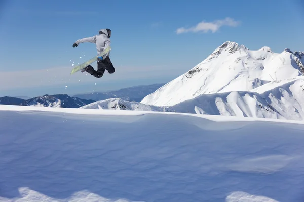 Flying snowboarder on mountains — Stock Photo, Image