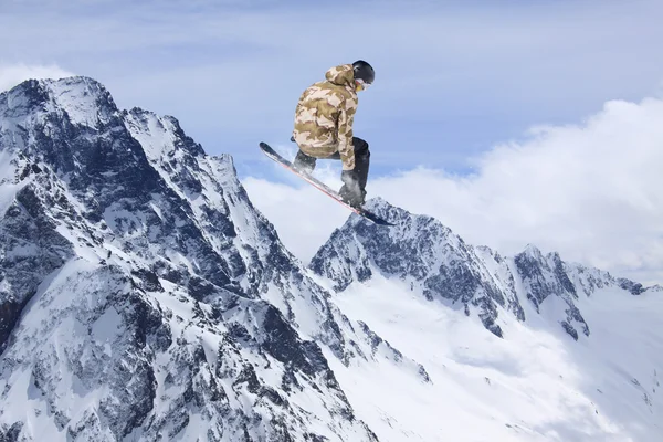 Létající snowboardista na horách. Extrémní sport — Stock fotografie