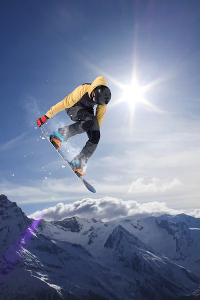 Létající snowboardista na horách. Extrémní sport. — Stock fotografie