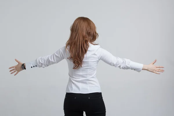 Woman stands back and raised her arms to the side — Stock Photo, Image