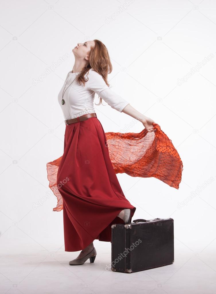 woman in skirt dancing with a red handkerchief