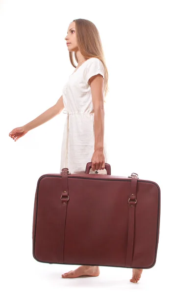 Woman going with heavy suitcase, isolated on white — Stock Photo, Image