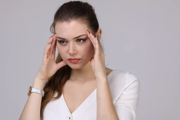 Mooie jonge vrouw met hoofdpijn aanraken haar tempels — Stockfoto