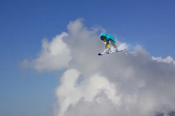 Um snowboarder voador nas montanhas. Desporto extremo. — Fotografia de Stock