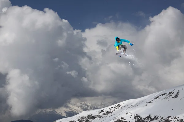 Repülő snowboardos a hegyekben. Extrém sport. — Stock Fotó