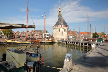 The harbor (Binnenhaven) of Hoorn, West Friesland, Netherlands, with the Hoofdtoren (The Head Tower) and old wooden sailing boats clipart