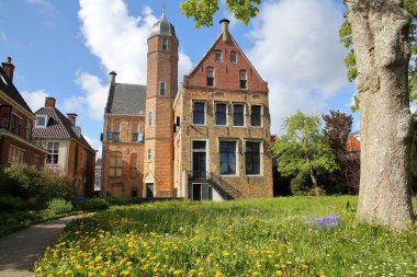 FRANEKER, NETHERLANDS - MAY 16, 2021: The external garden and the medieval facade of Museum Martena in Franeker, Friesland