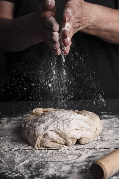 Cooking dough by elderly woman cook hands for homemade pastry bread, pizza, pasta recipe preparation on table background.