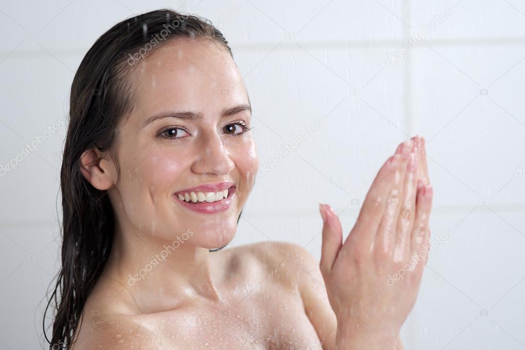 a woman standing at the shower
