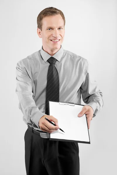 Business man with clipboard — Stock Photo, Image