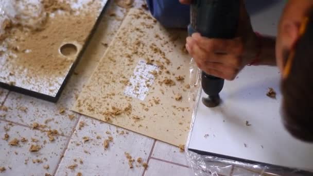 Process of apartment renovation. drilling holes in furniture by fettler. sawdust scatter. unrecognizable men. remodeling, doing repairs. FullHD footage — Stock Video