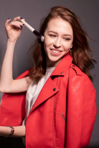 Charming Brunette Woman Red Leather Jacket Makeup Brushes Isolated Grey — Stock Photo, Image