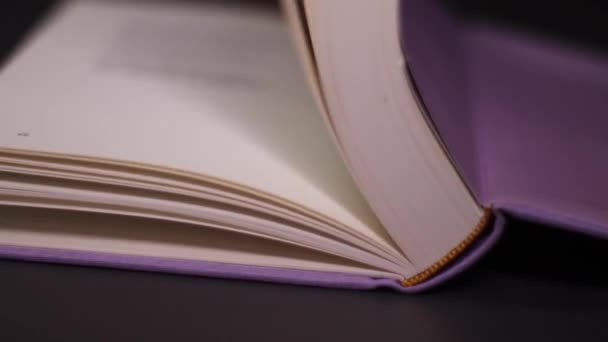 最后的紫罗兰色书的宏观镜头 书页翻页的遮掩 喜欢阅读的概念 单张上不可辨认的文本的详细视图 — 图库视频影像