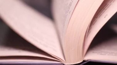 Macro kitabın sayfalarını çevirirken çekti. Sayfaların sayfalarını kapatıyoruz. Öğrenme ve eğitim kavramı. Masadaki kitap sayfalarında tanımlanamayan metnin ayrıntılı görünümü