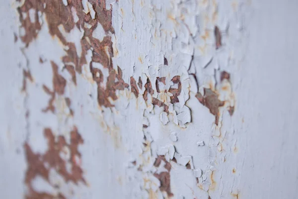 Old cracked paint on wall. Texture, pattern, background. wall cracked with paint, abstract paint behind the iron. close up