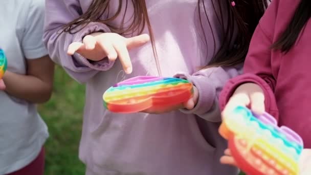 Child unrecognizable hands play trendy silicon fidgeting game sensory toy pop it. rainbow soft silicone bubbles. anxiety relief, antistress, mental health concept. Anti stress game popit. slow motion — Stock Video