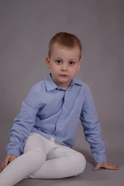 Charmante Kleine Kleuter Witte Broek Blauw Shirt Grijze Achtergrond Kind — Stockfoto