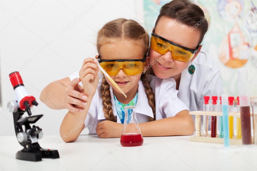 Young teacher with little student at elementary science class